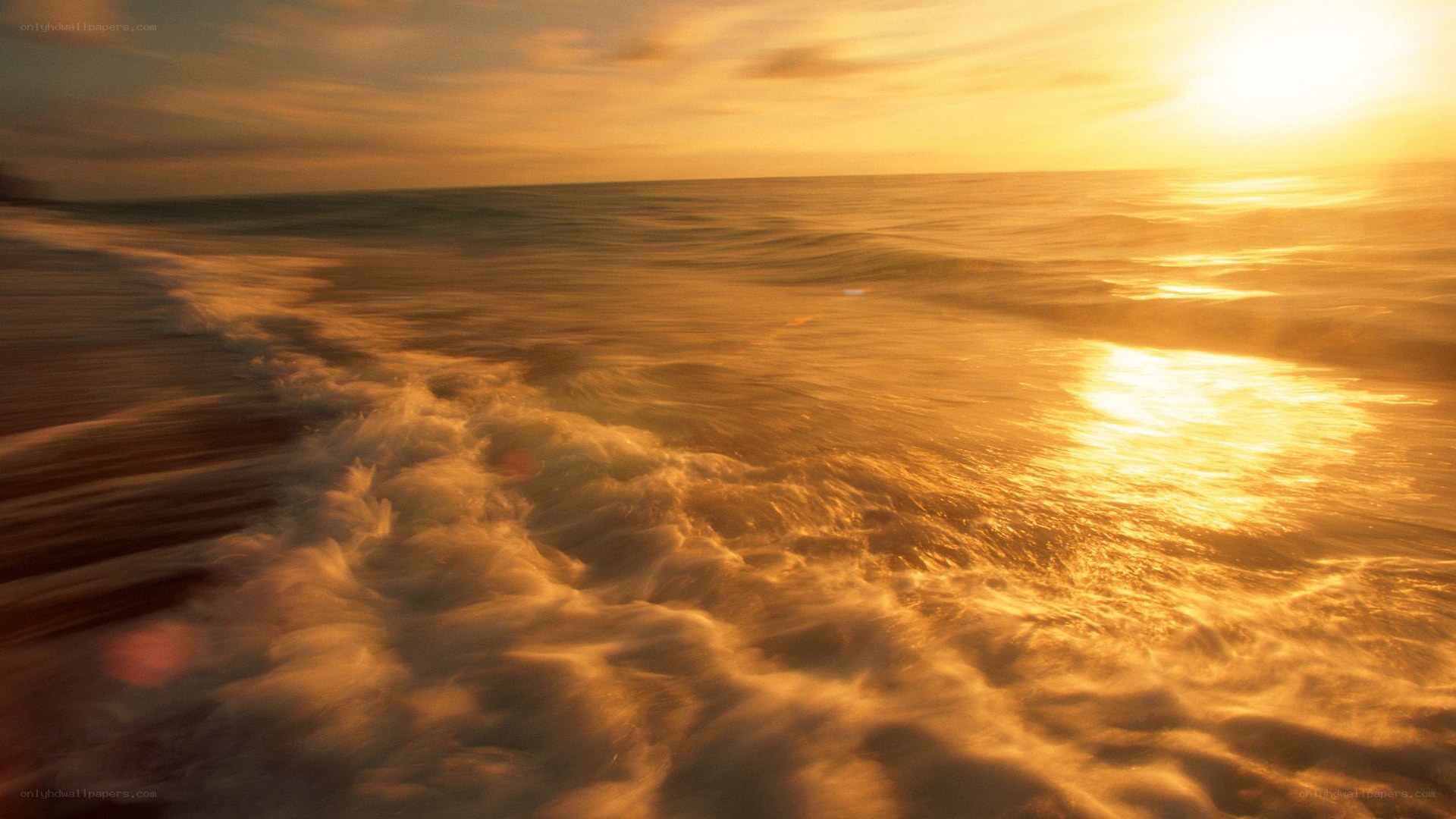 Golden sunset over ocean waves