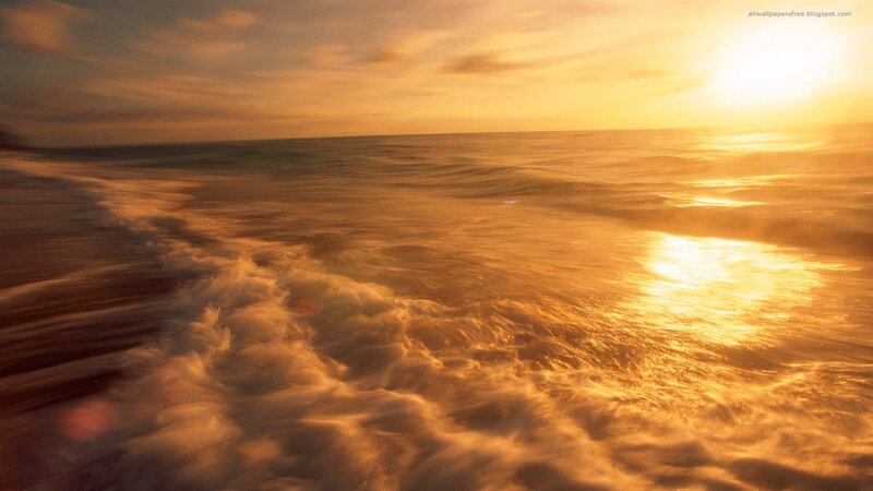 Golden sunset over ocean waves