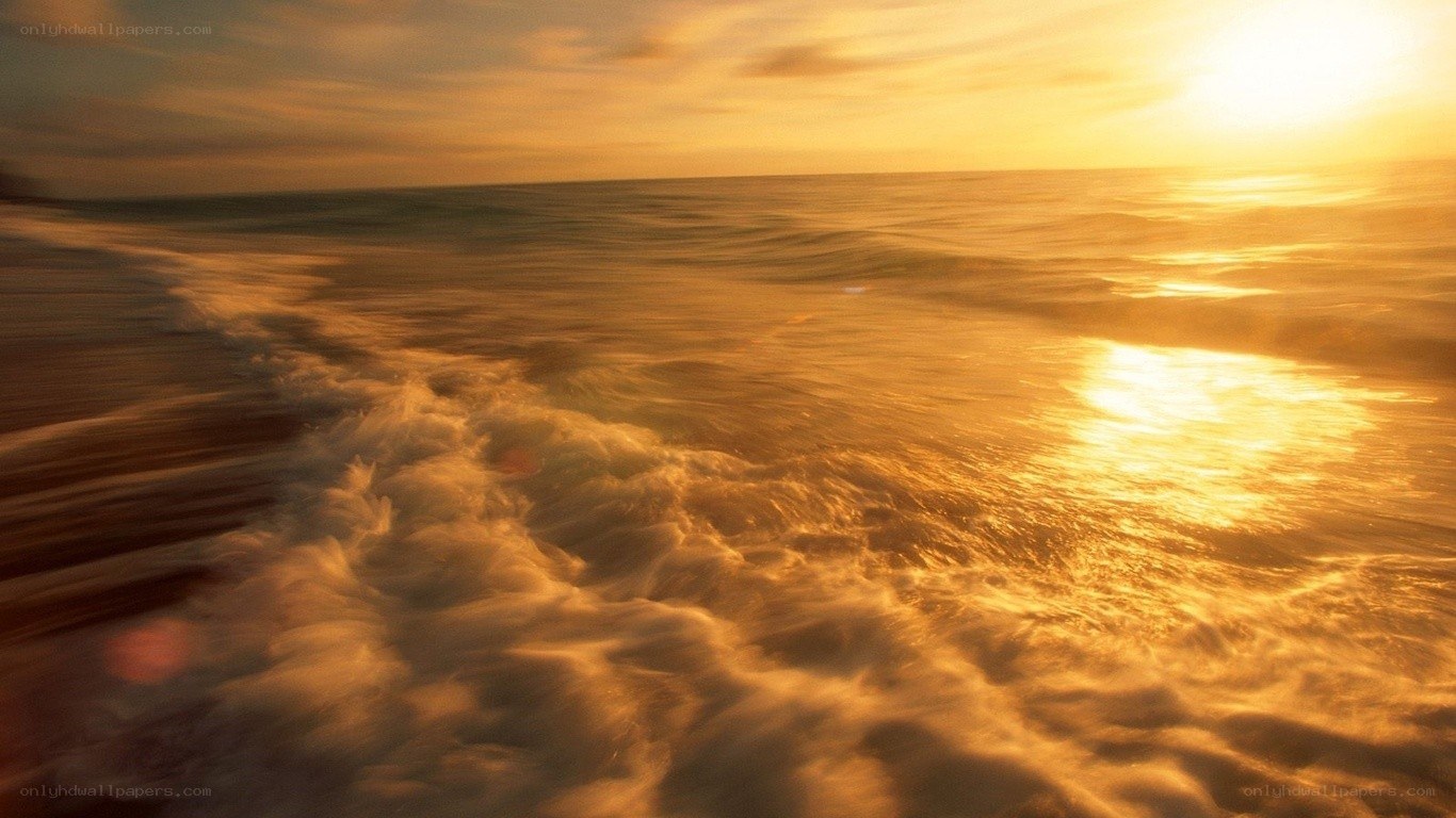 Golden sunset over ocean waves
