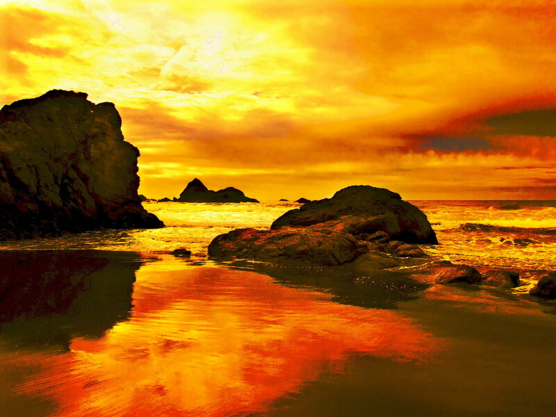 Golden sunset over rocky beach