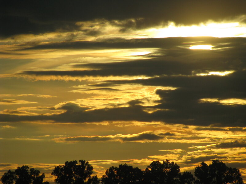 Golden sunset through clouds