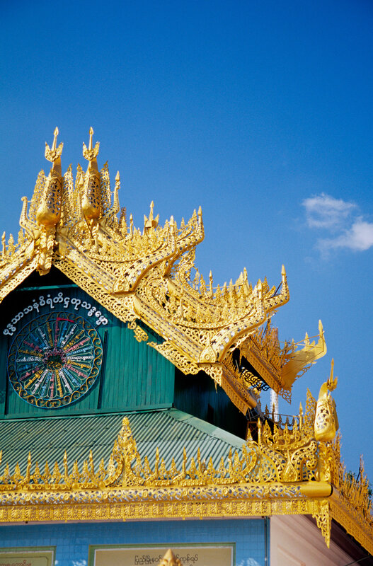 Golden temple roof against blue sky