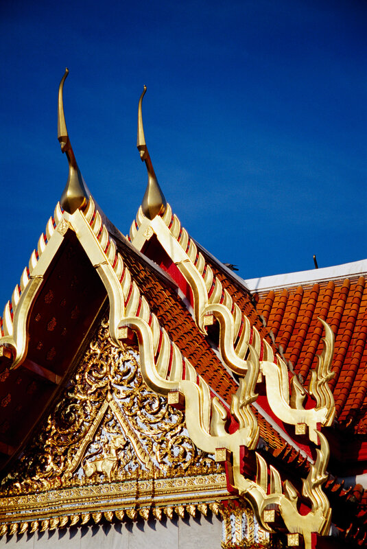 Golden temple roof against blue sky