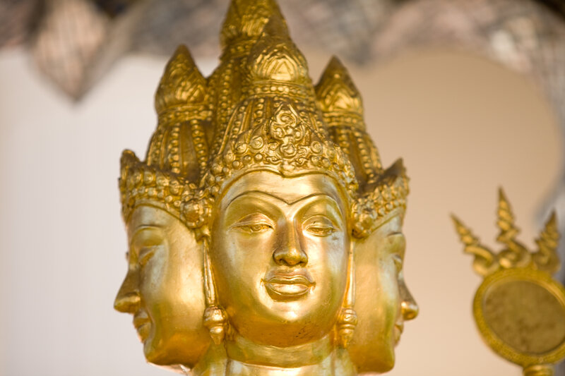 Golden three-faced deity statue