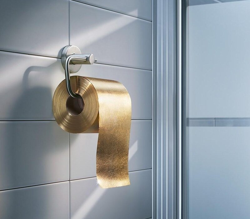 Golden toilet paper in bathroom