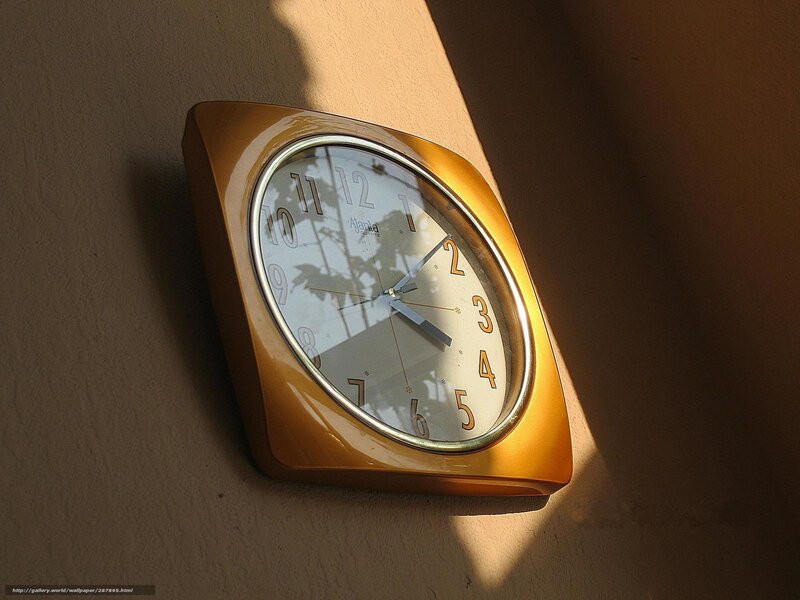 Golden wall clock in sunlight