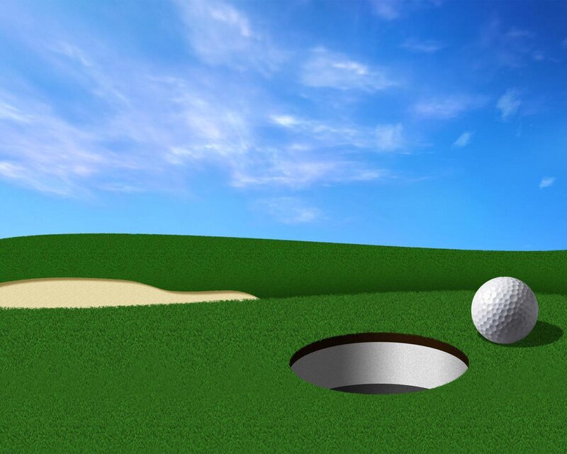 Golf ball near hole on green