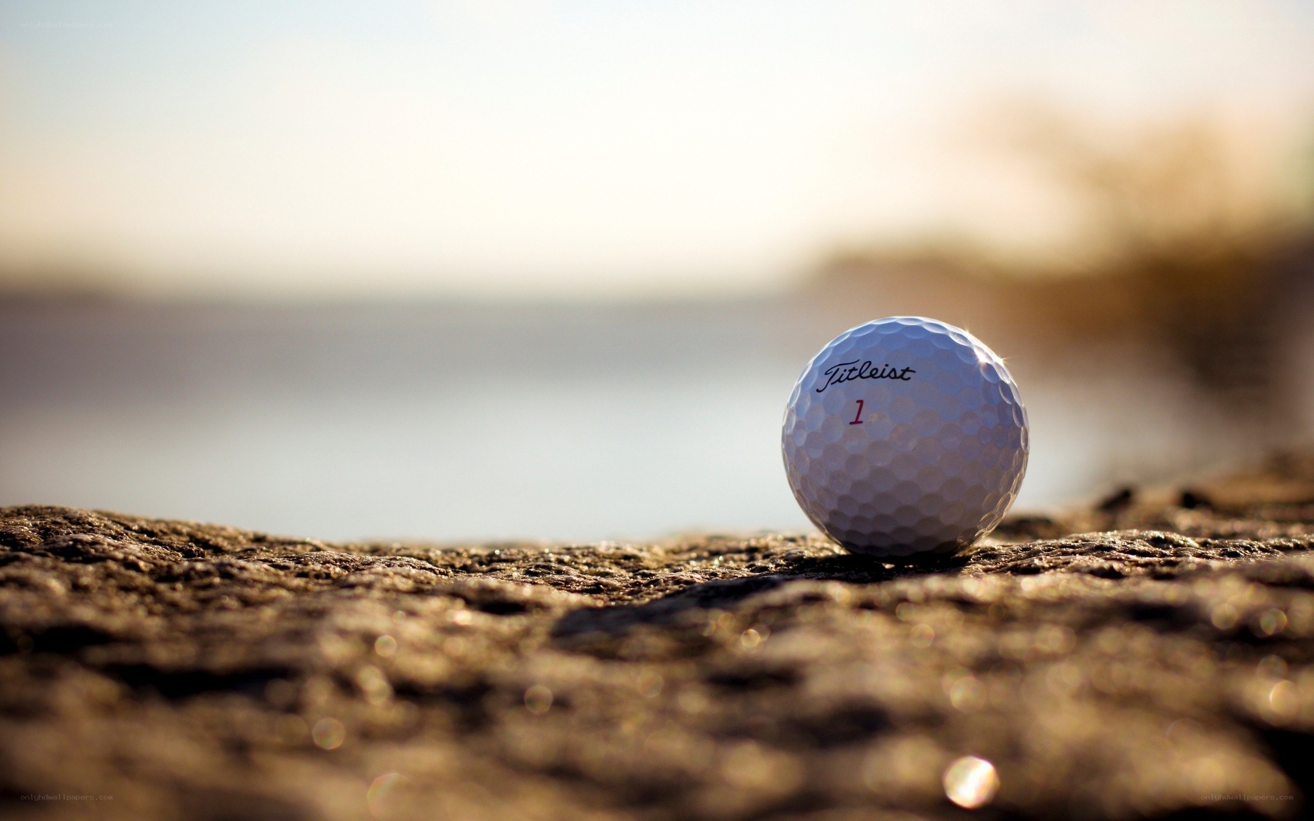 golf ball on rock at sunset