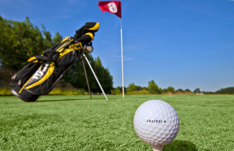Golf ball on tee with bag