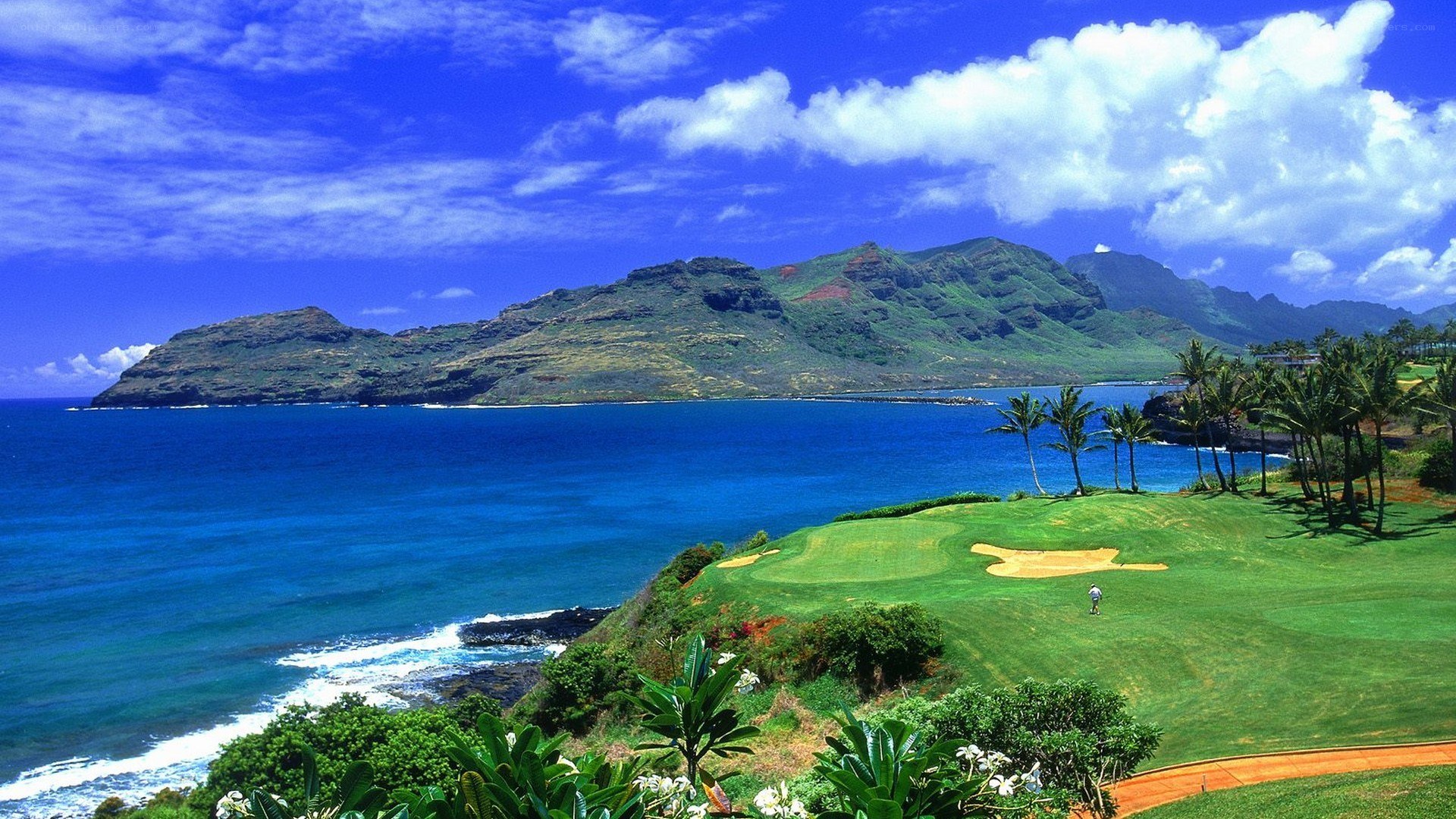 Golf course overlooking ocean and mountains