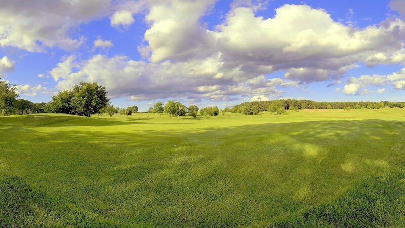 Golf course under cloudy sky