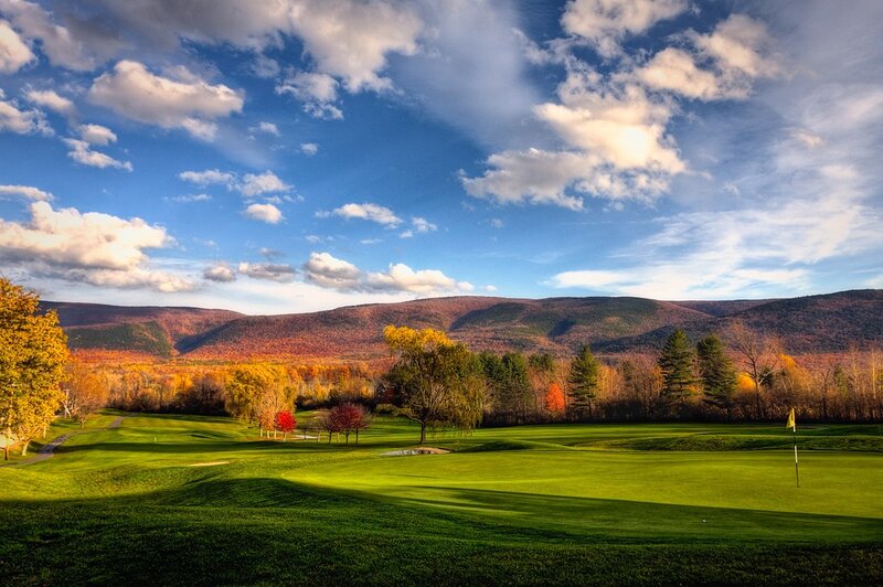 Golf course with autumn mountains
