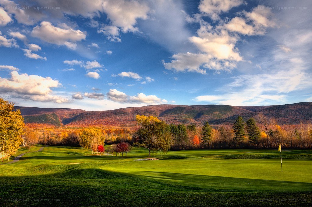 Golf course with autumn mountains