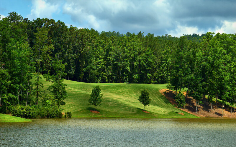 Golf course with lake and trees