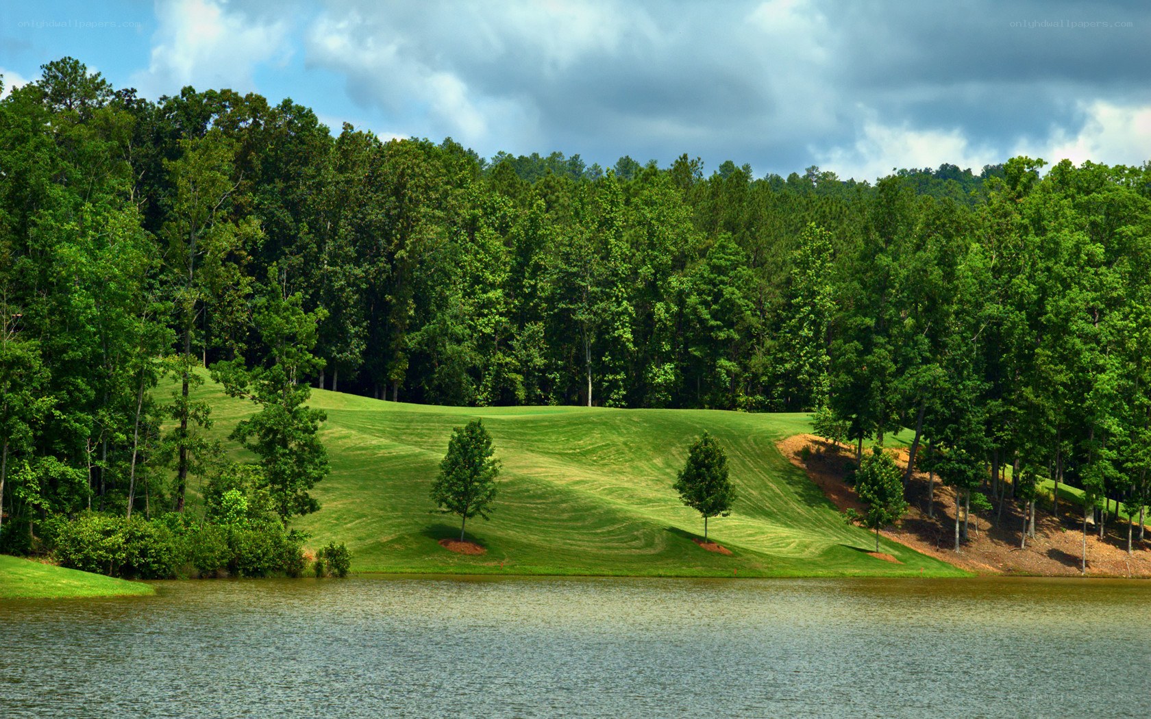 Golf course with lake and trees