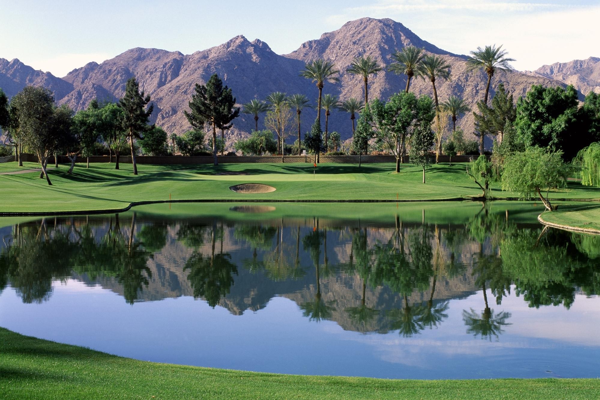 Golf course with mountain reflection