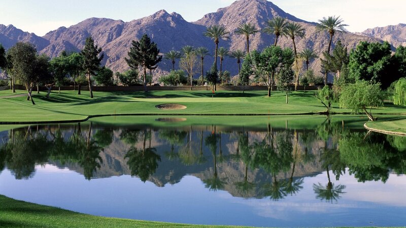 Golf course with mountain reflection