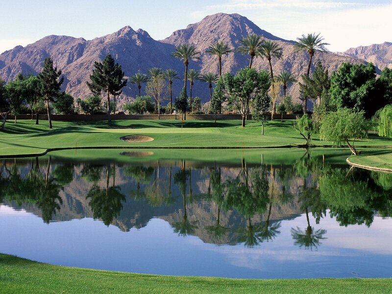 Golf course with mountain reflection