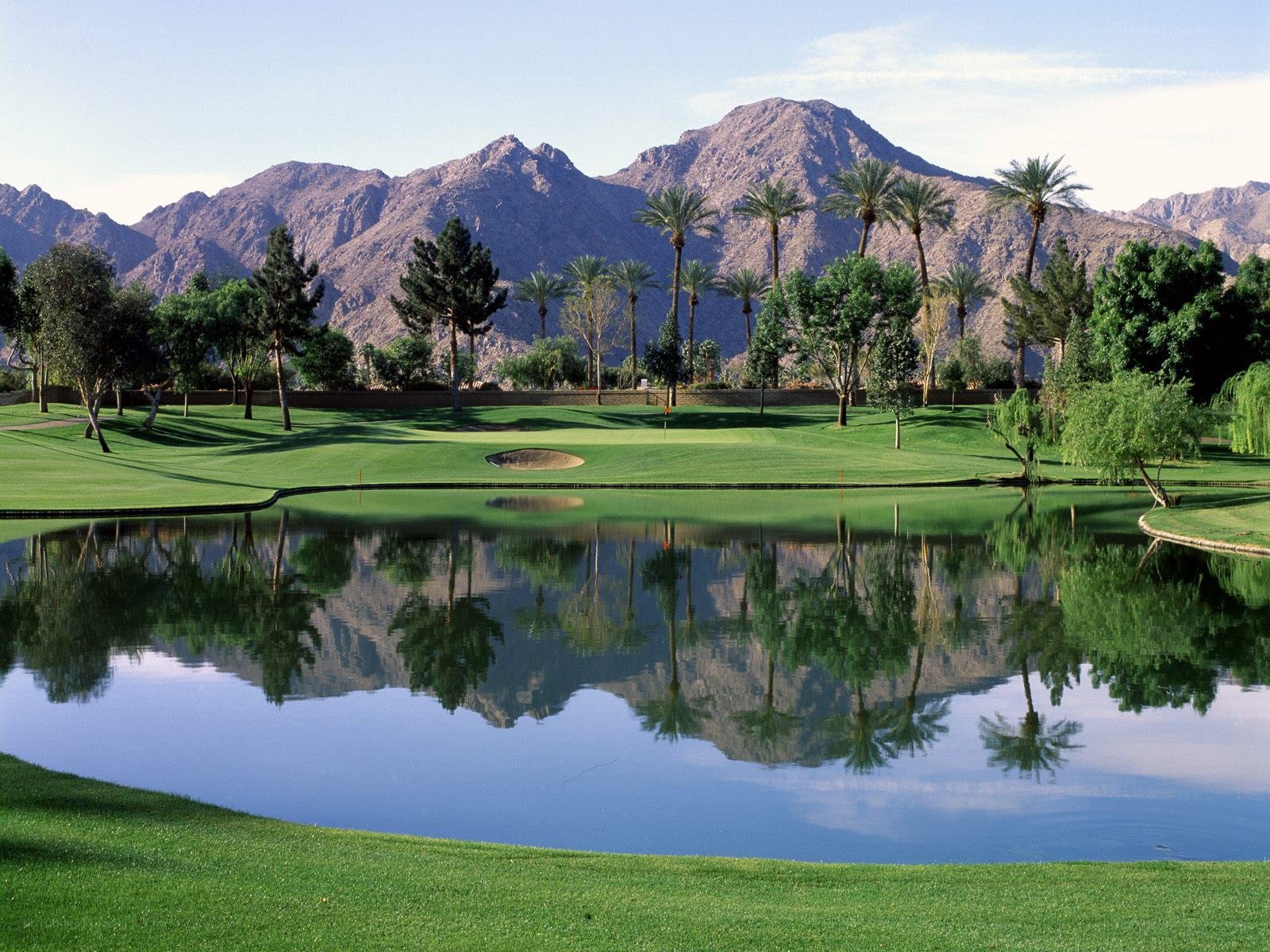 Golf course with mountain reflection