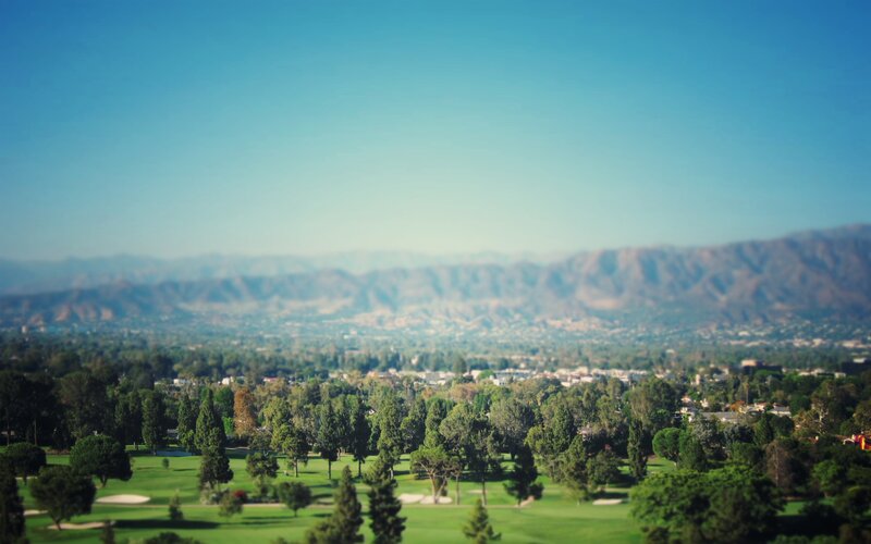 Golf Course with Mountains — Green, Serene, Afternoon, Photograph, Trees, City