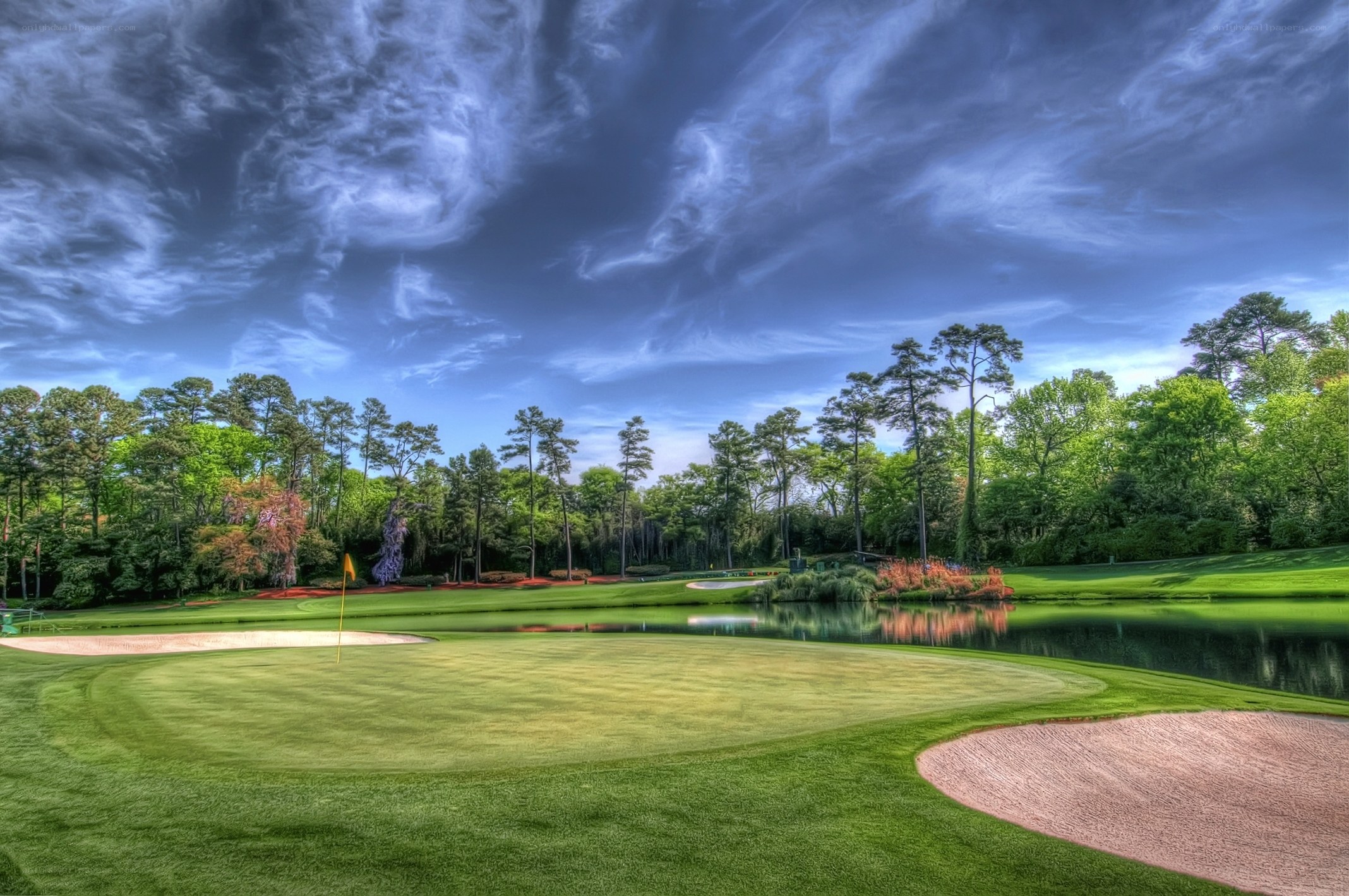 Golf course with pond and trees