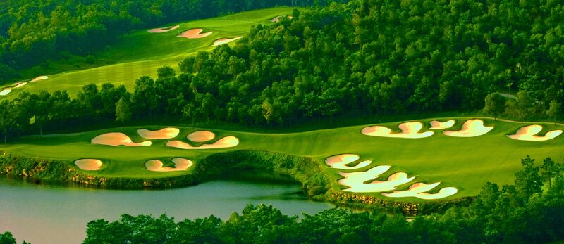 Golf course with sand traps and water hazard