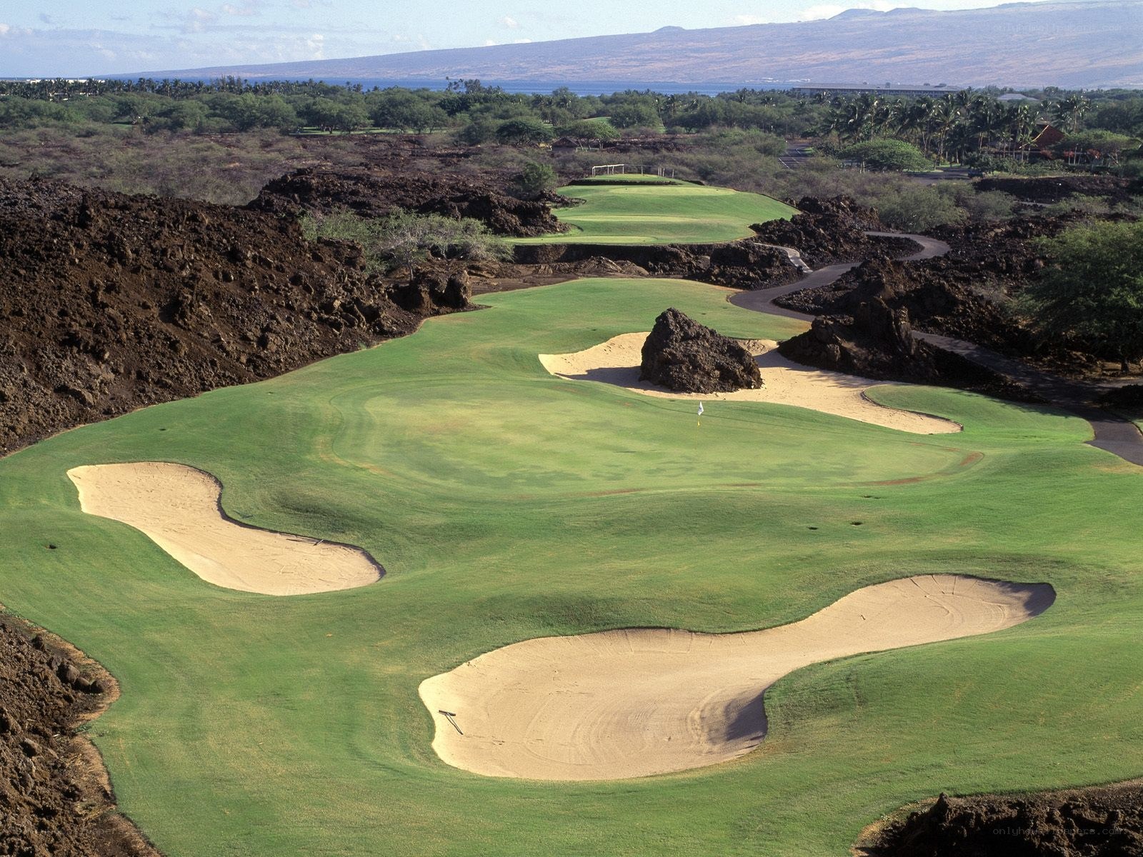 golf course with volcanic rocks