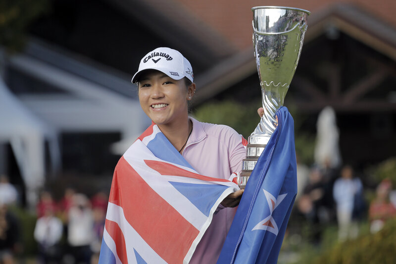 Golfer holding trophy