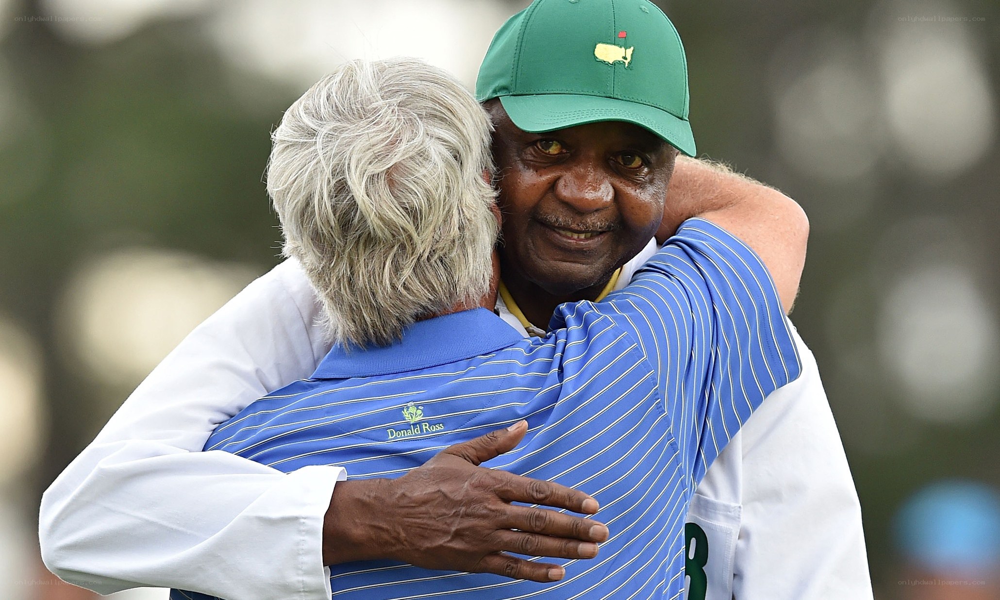 Golfer hugging another man