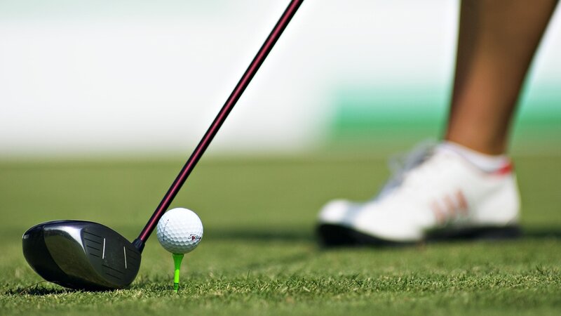 Golfer preparing to tee off