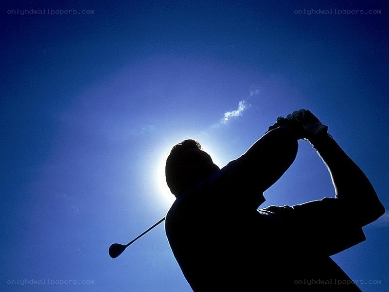 golfer silhouetted against sun