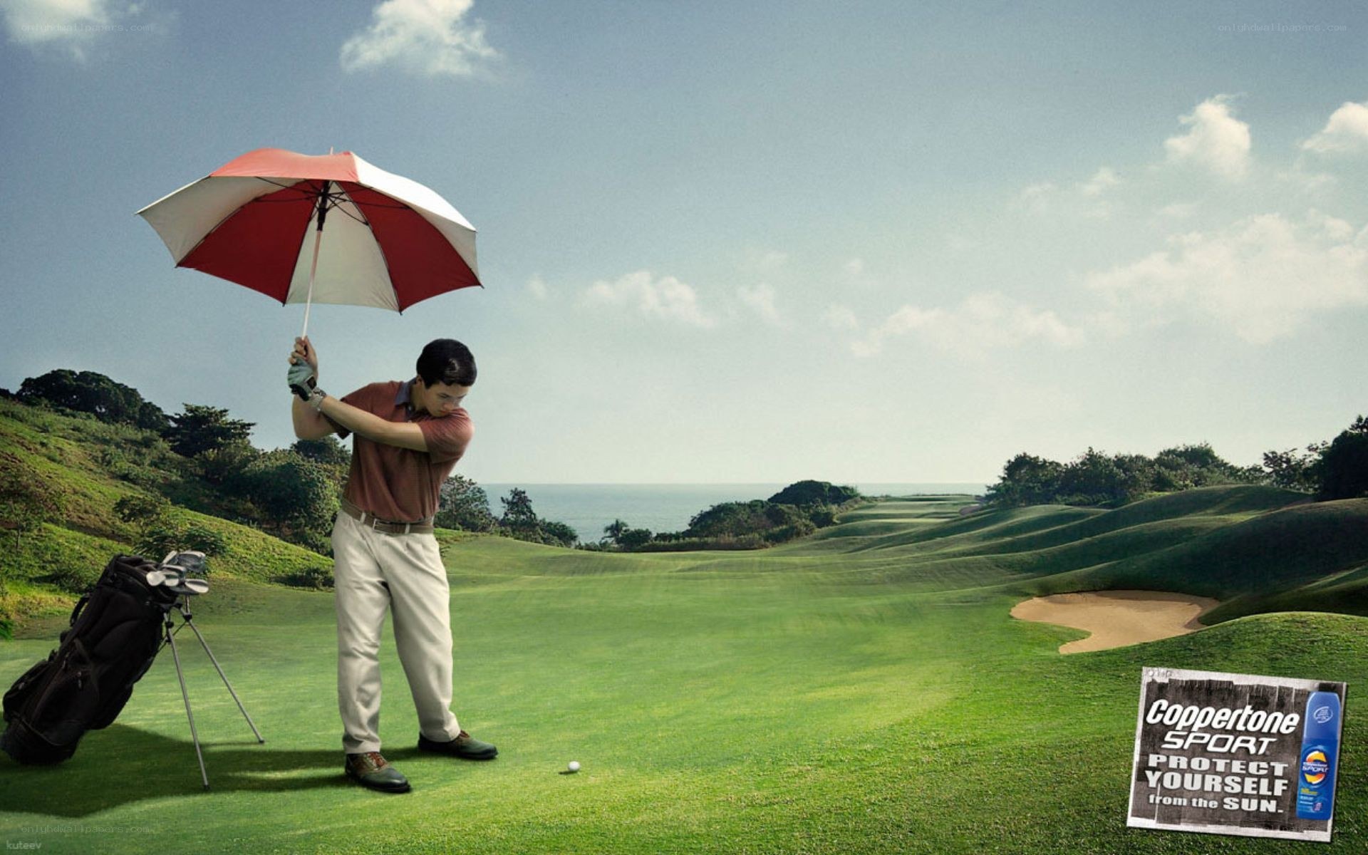 Golfer with umbrella on course