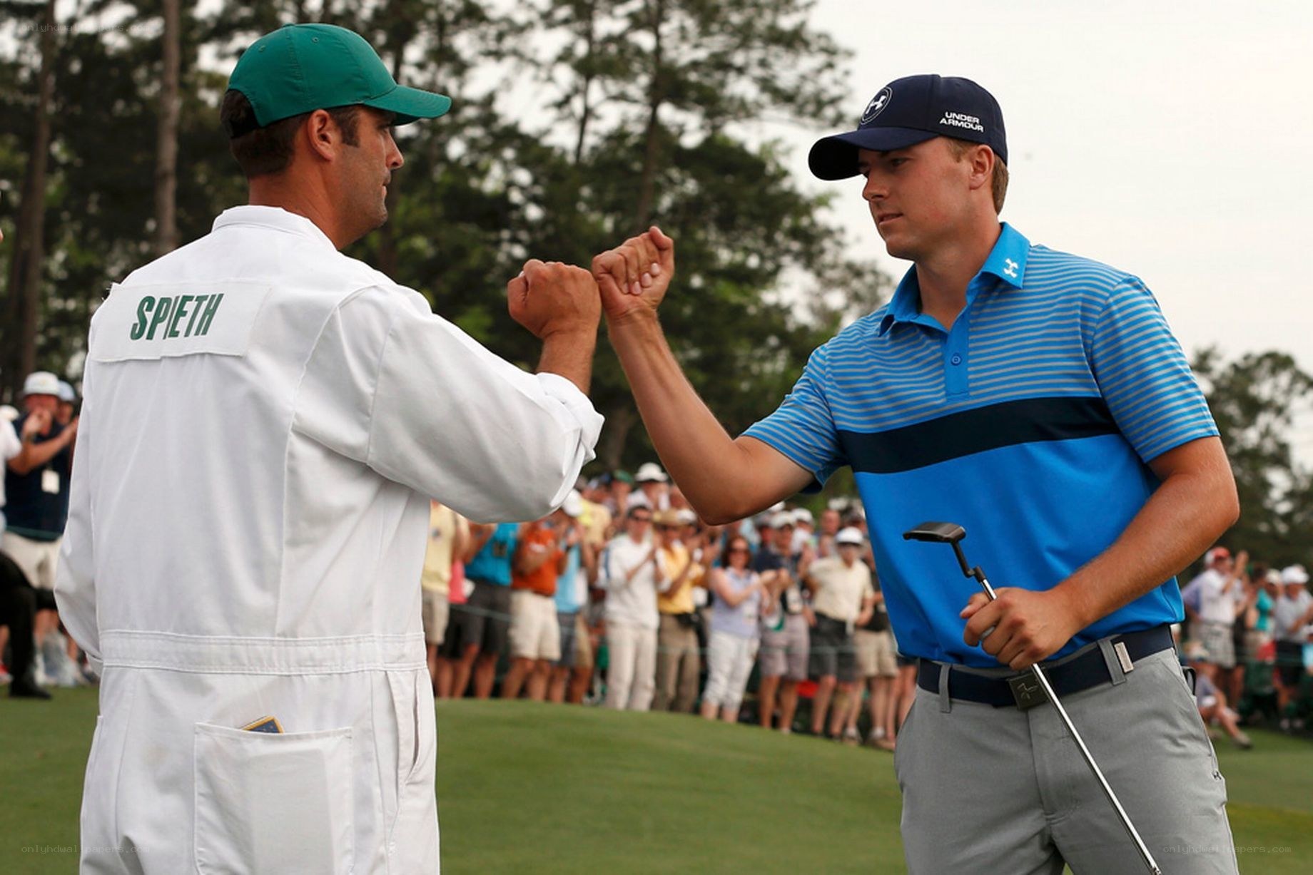 Golfers fist bump on course