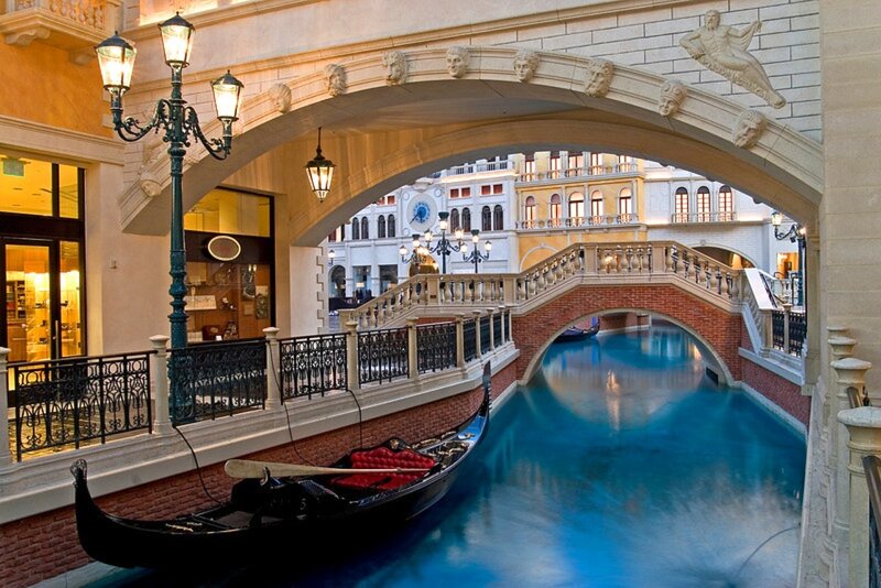 Gondola on a canal under an arch
