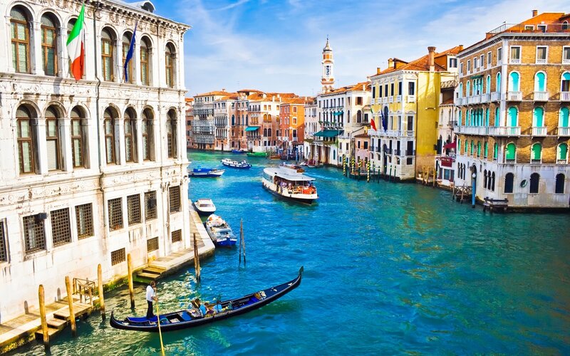 Gondola on Canal — Blue, Serene, Afternoon, Photograph, Boats, Buildings, Flag, White