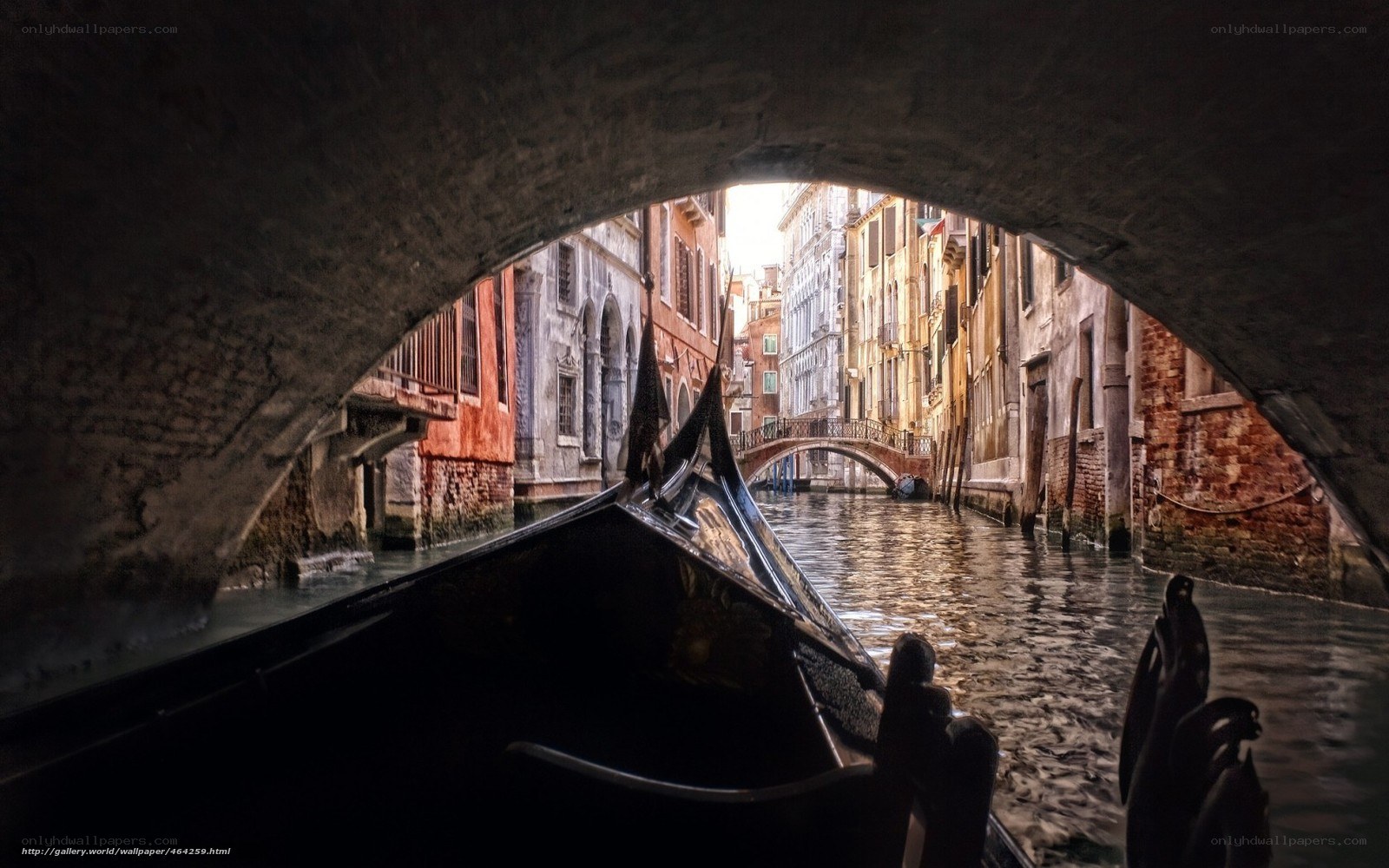 Gondola under a bridge in Venice