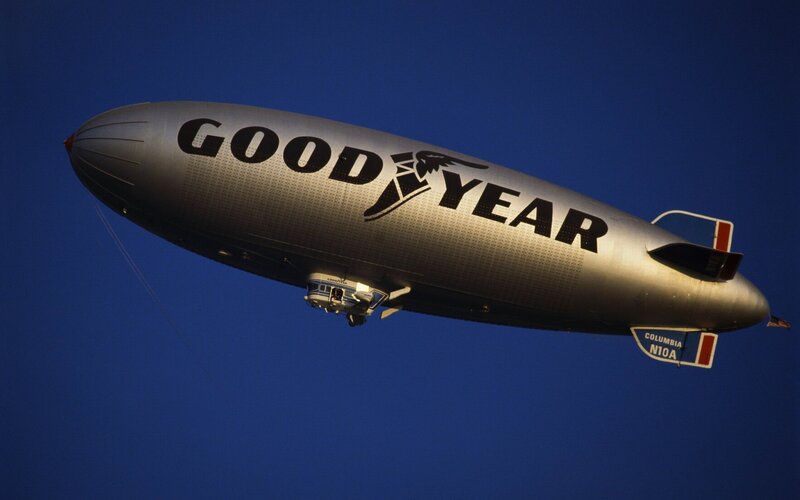 Goodyear Blimp in Flight — Blue, Dramatic