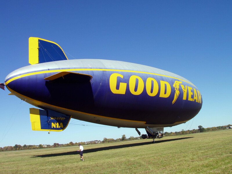 Goodyear blimp on grass field