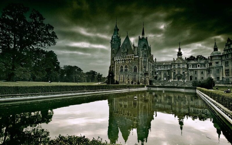 Gothic castle reflected in pond