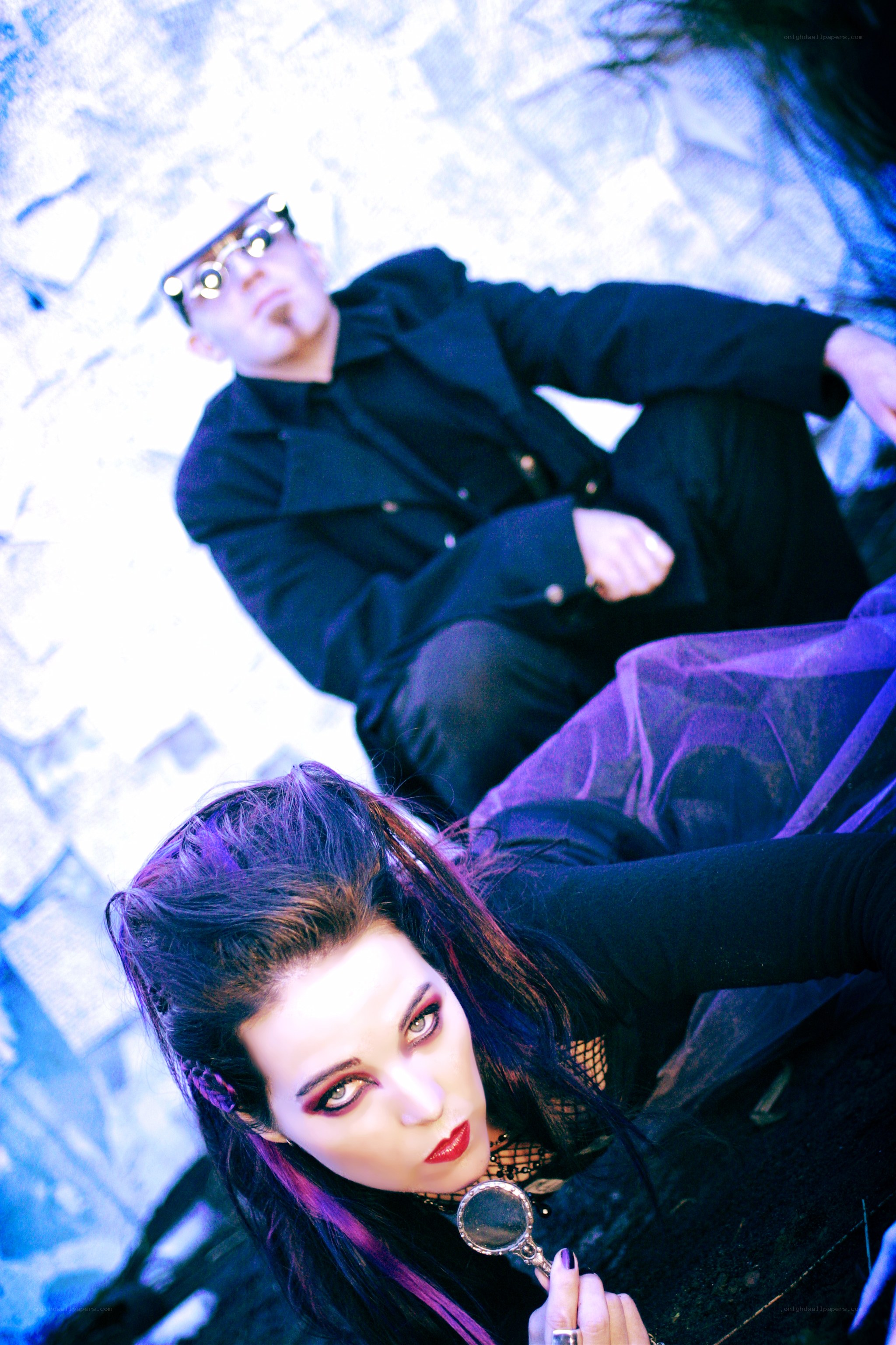gothic couple with magnifying glass