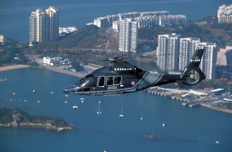 Government helicopter over coastal city