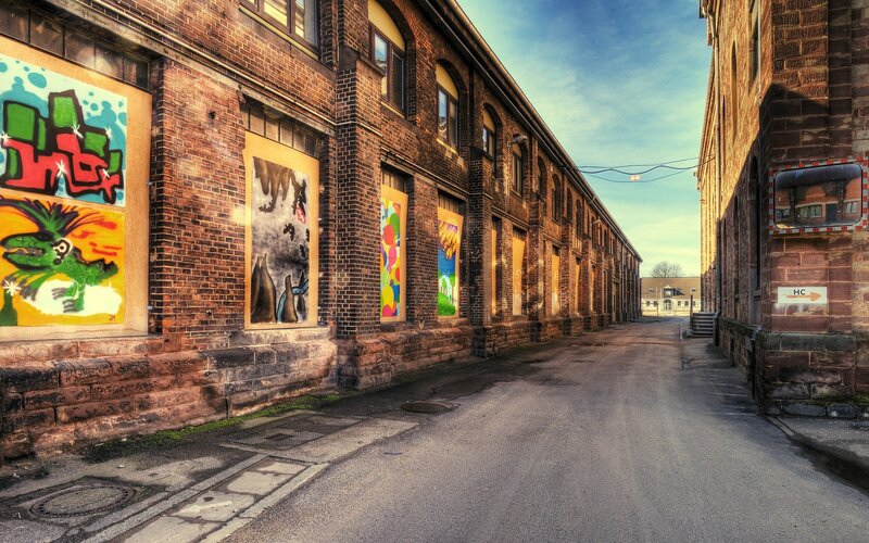 Graffiti alley between brick buildings