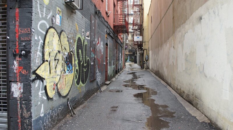 graffiti alley with puddles