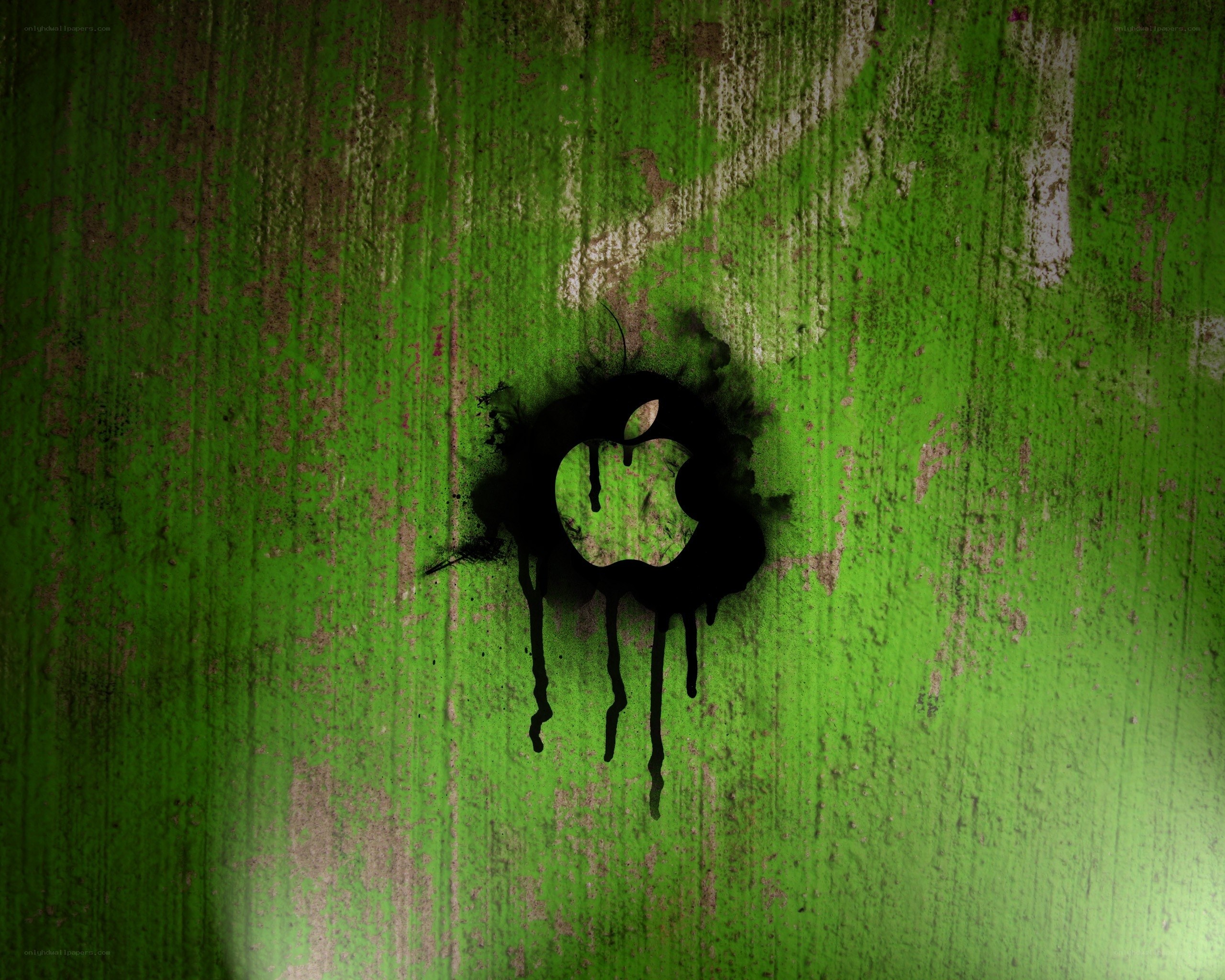 graffiti apple logo on green wall
