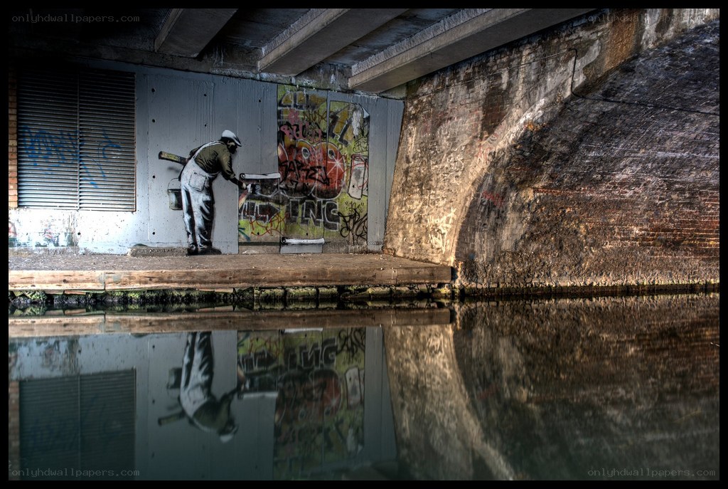 graffiti artist under bridge