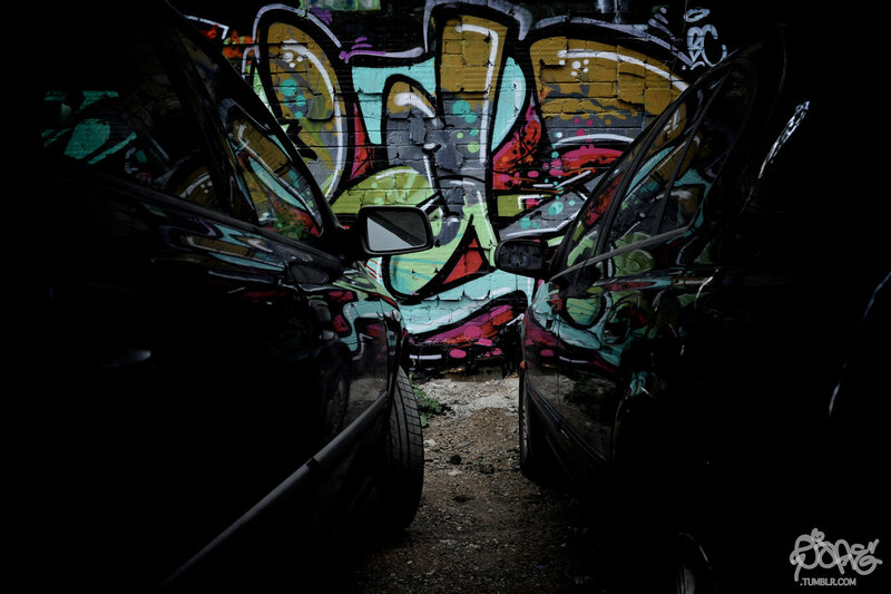 Graffiti between parked cars