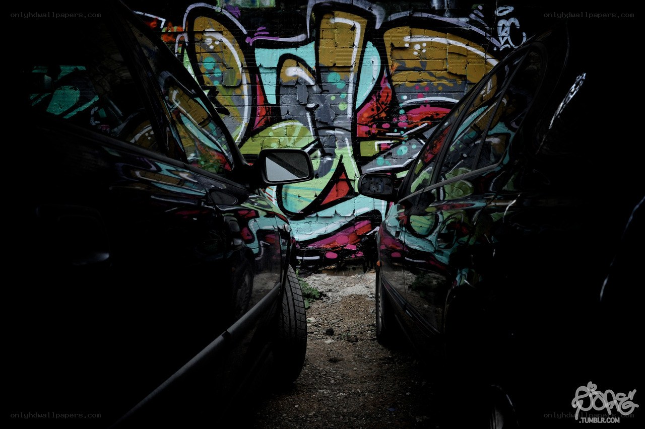 Graffiti between parked cars