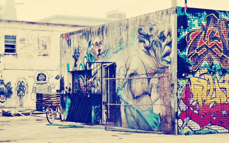 graffiti-covered alley with murals