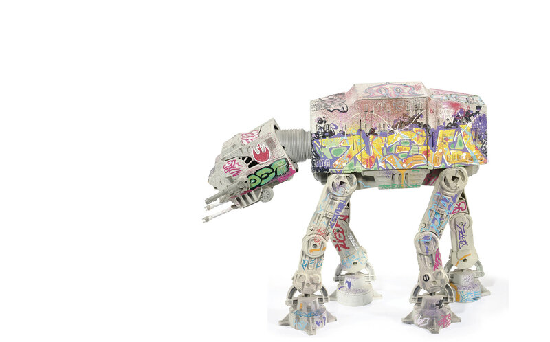 graffiti-covered at-at toy