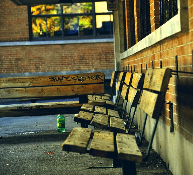 Graffiti-covered benches in alley